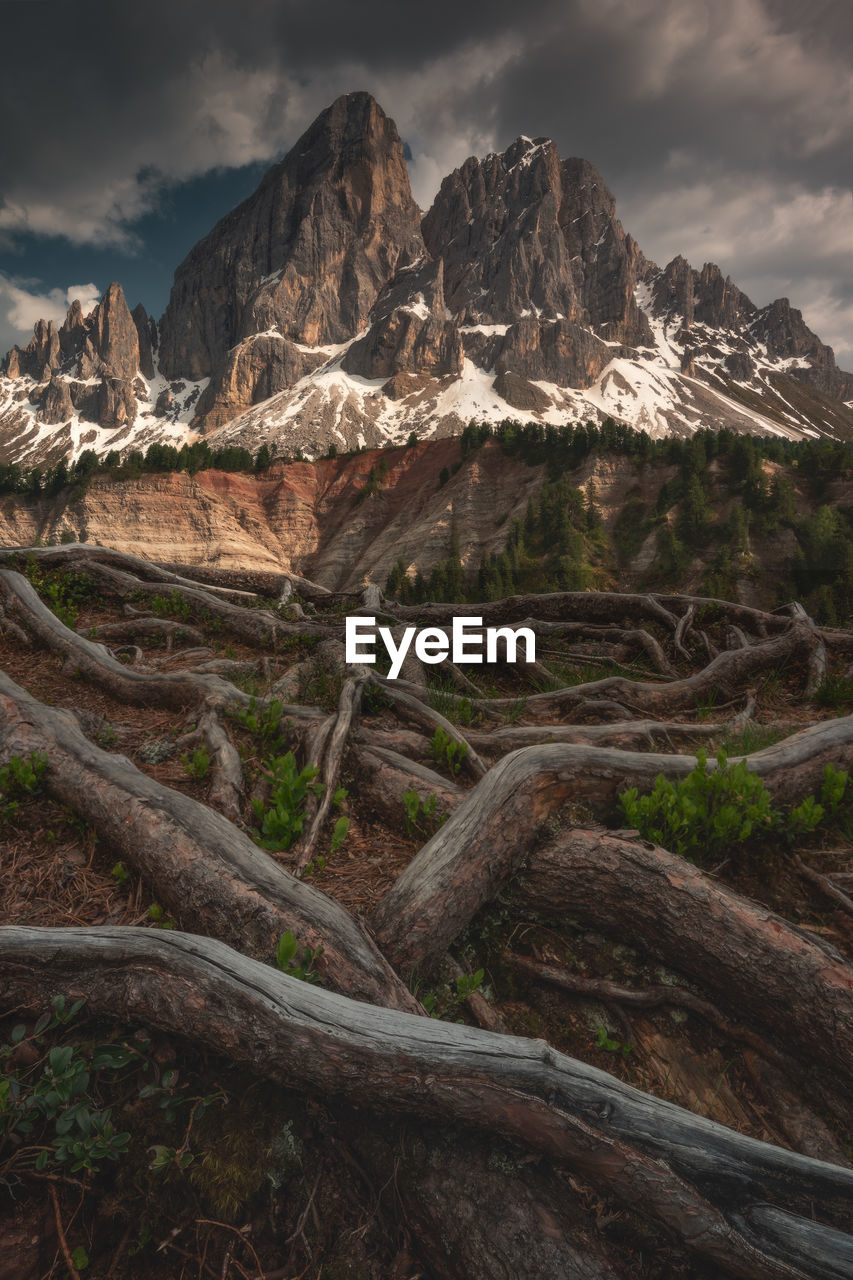 scenic view of mountains against cloudy sky