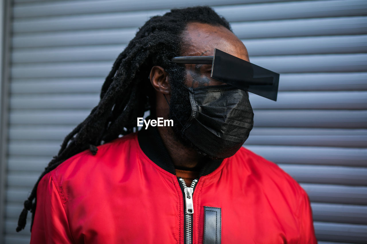 Stylish african man in black mask and glasses