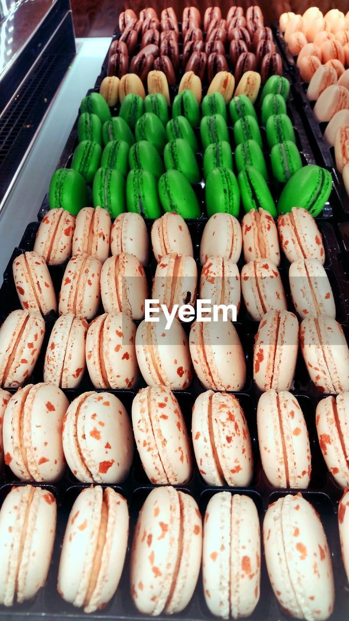 High angle view of various macaroons for sale in market