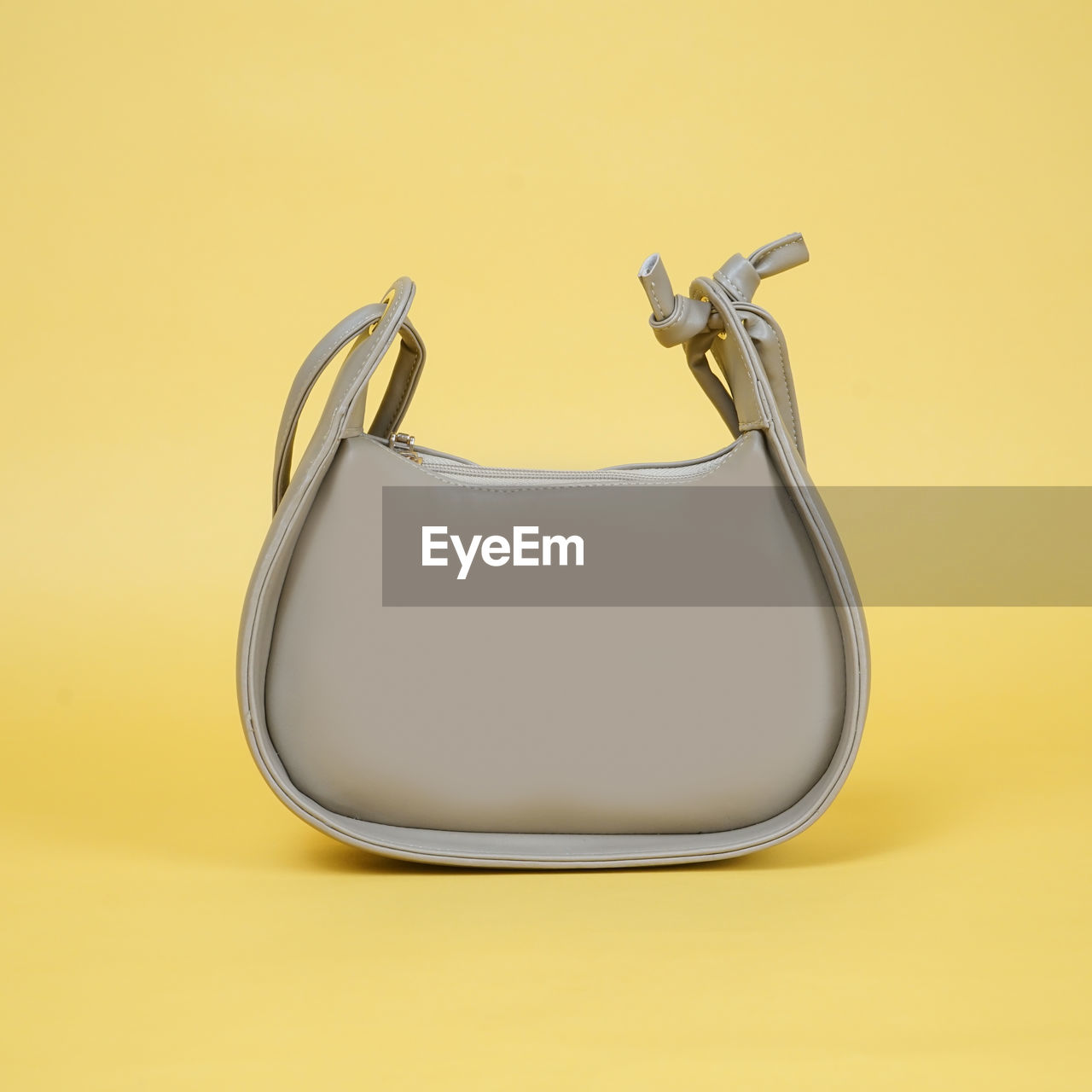 colored background, studio shot, yellow, yellow background, indoors, no people, single object, handbag, copy space, cut out, metal