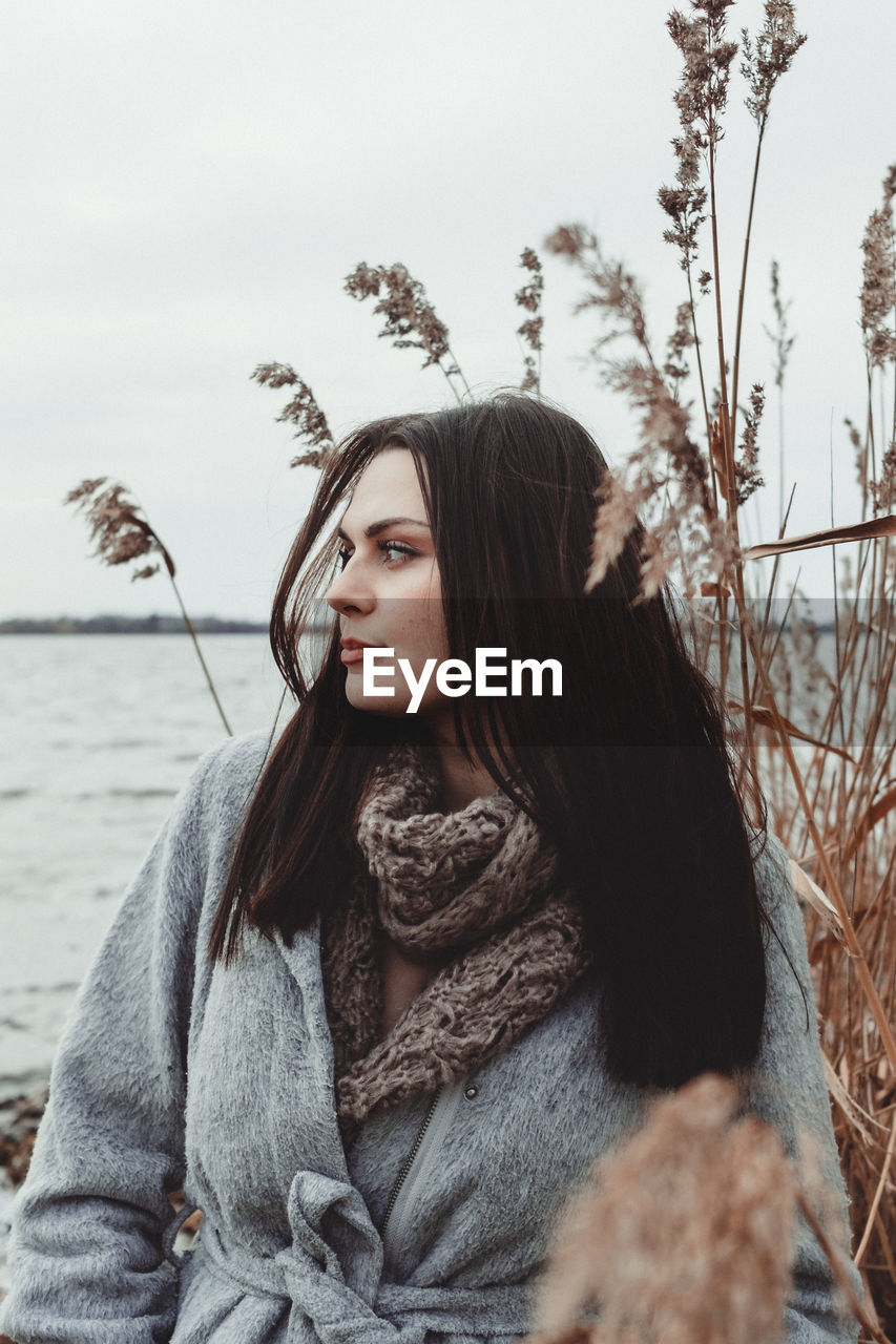 Portrait of young woman looking away in winter