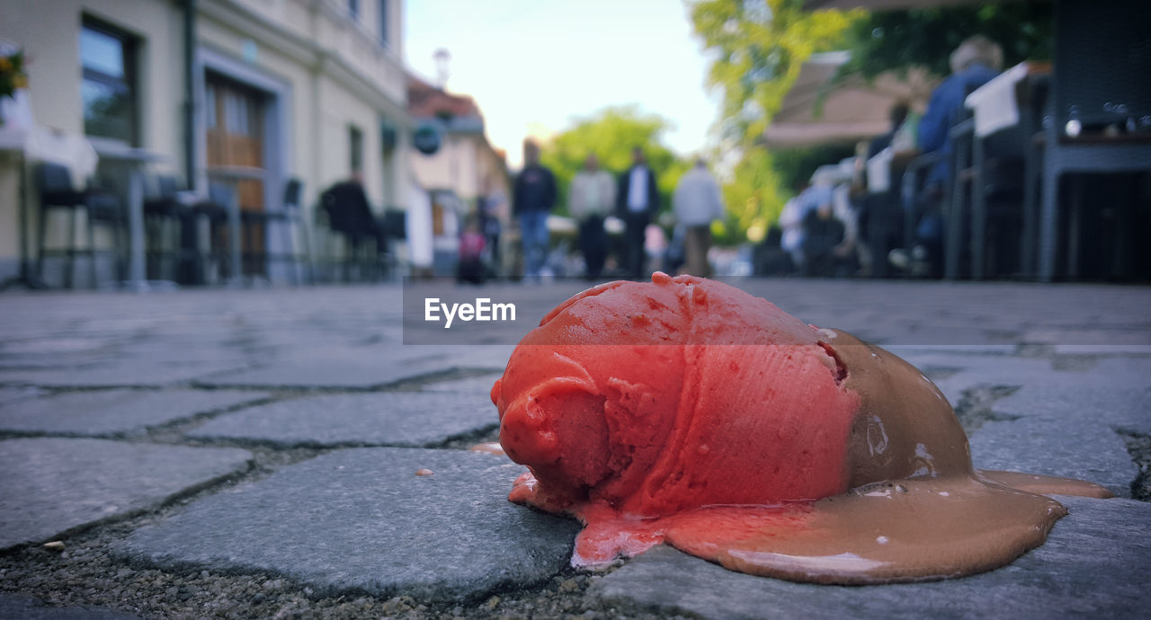 Close-up of fallen ice cream on street