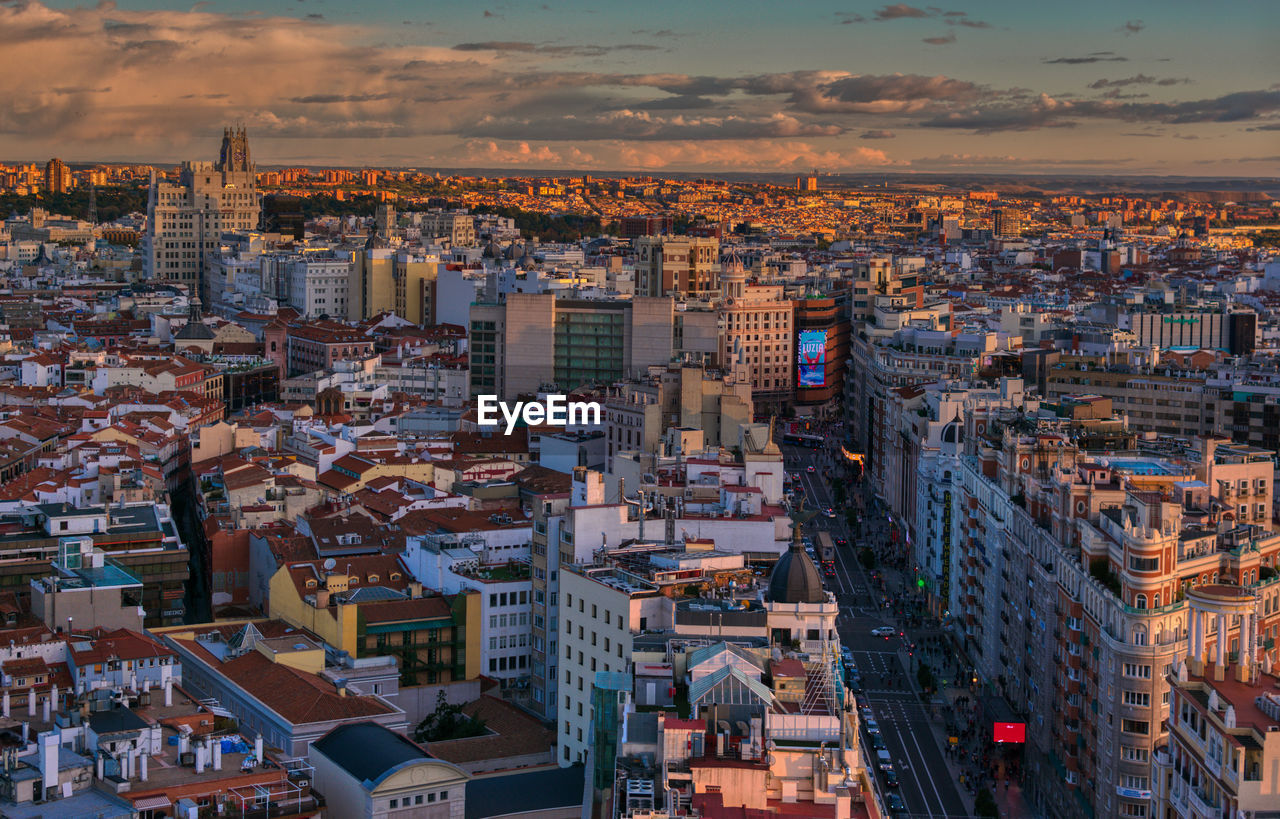 architecture, city, cityscape, building exterior, built structure, building, urban area, skyline, metropolis, sky, metropolitan area, residential district, landscape, sunset, high angle view, travel destinations, crowd, nature, aerial photography, horizon, town, dusk, neighbourhood, residential area, travel, urban skyline, office building exterior, evening, crowded, aerial view, city life, skyscraper, street, bird's-eye view, downtown, outdoors, business finance and industry, roof, night, transportation, illuminated, tourism, environment, cloud, city street, house, road, downtown district