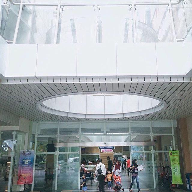 WOMAN STANDING ON ESCALATOR