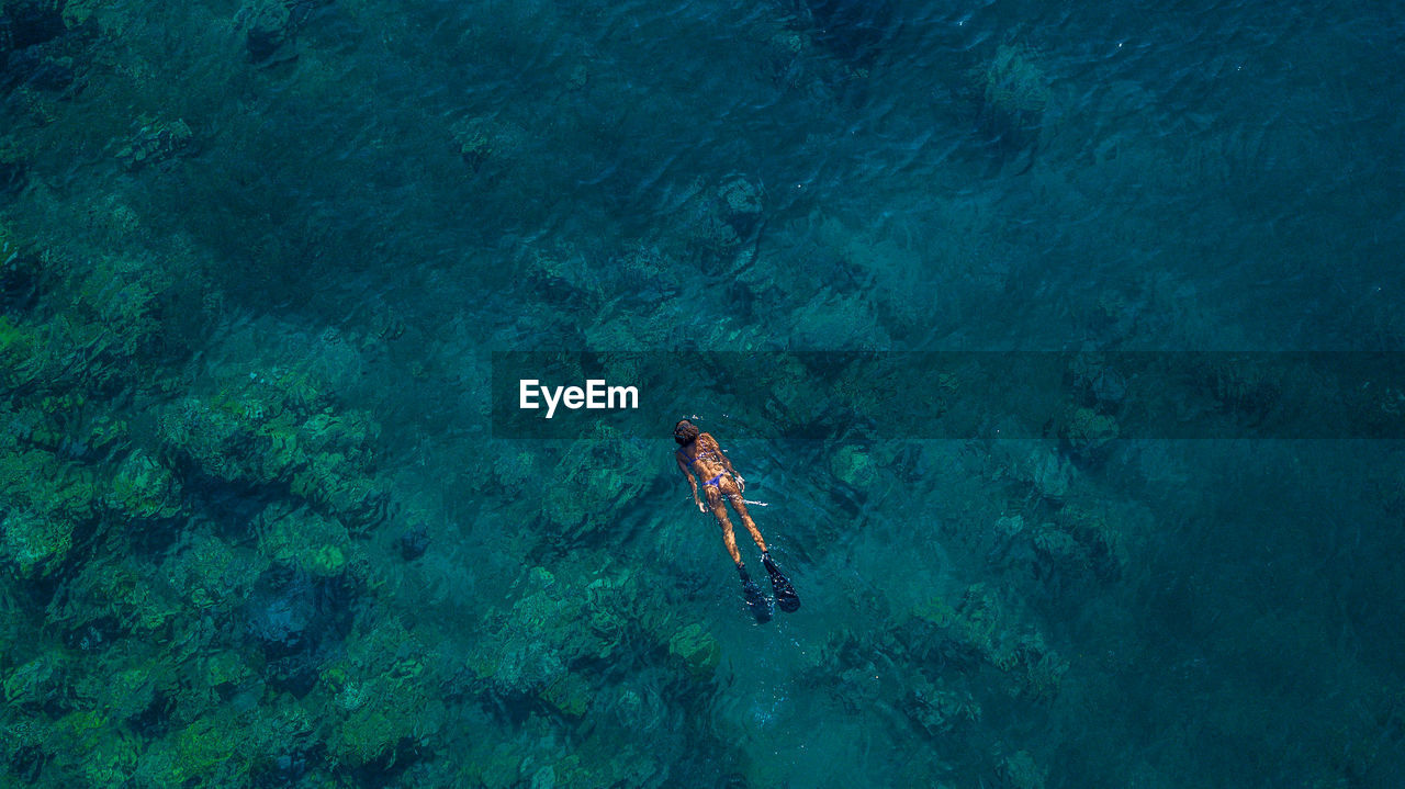 Aerial view of woman swimming in sea