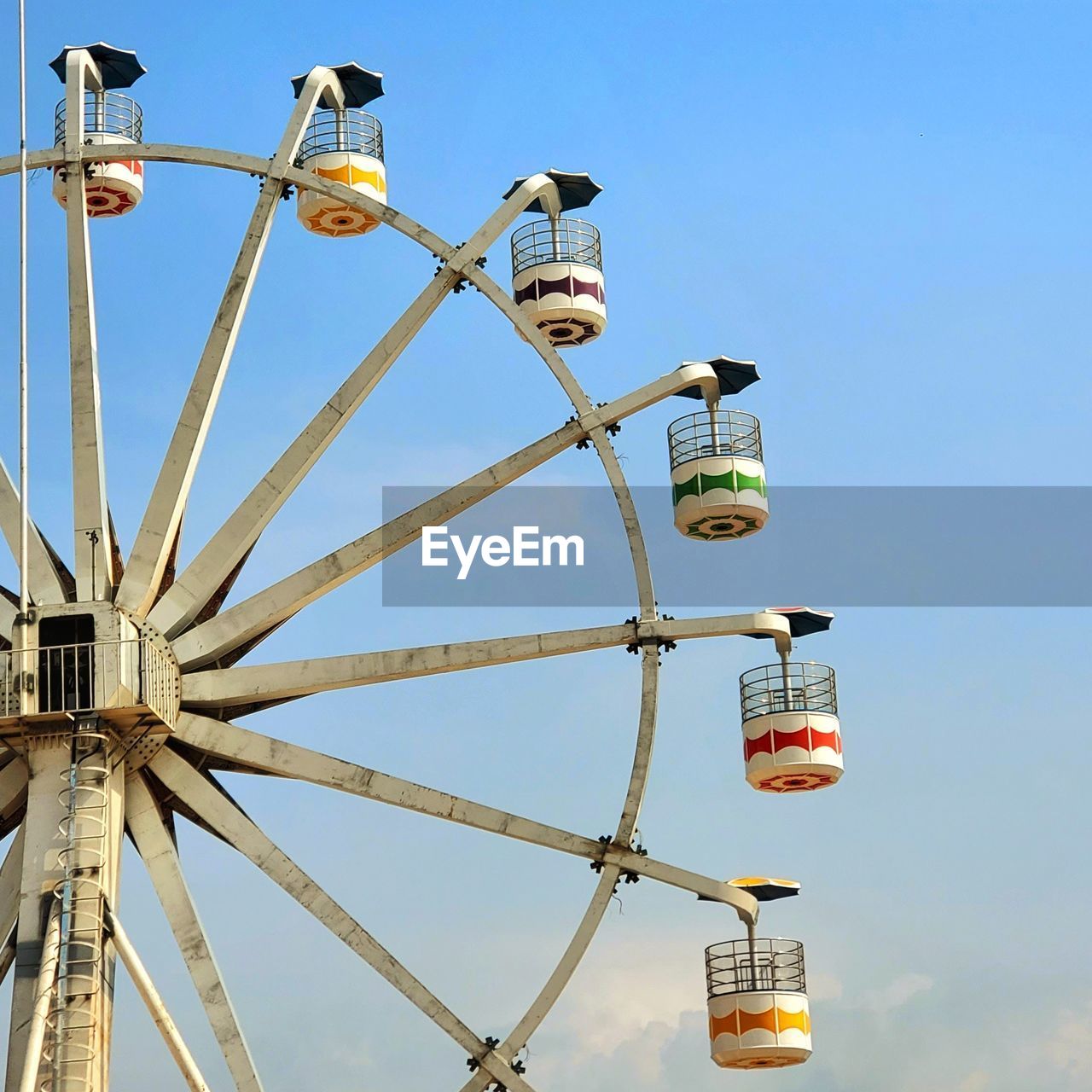 low angle view of ferris wheel against blue sky