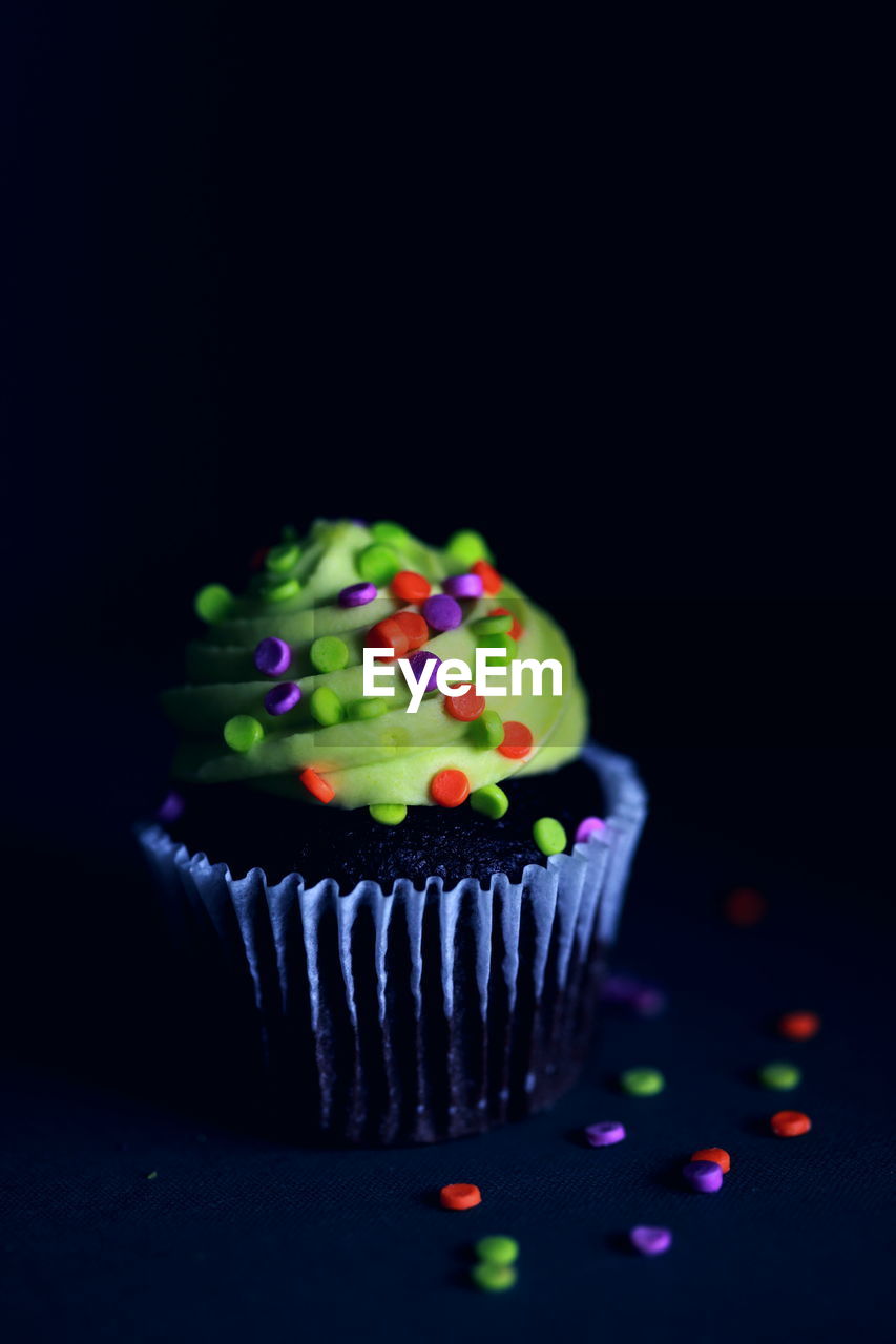 Close-up of cupcake against black background