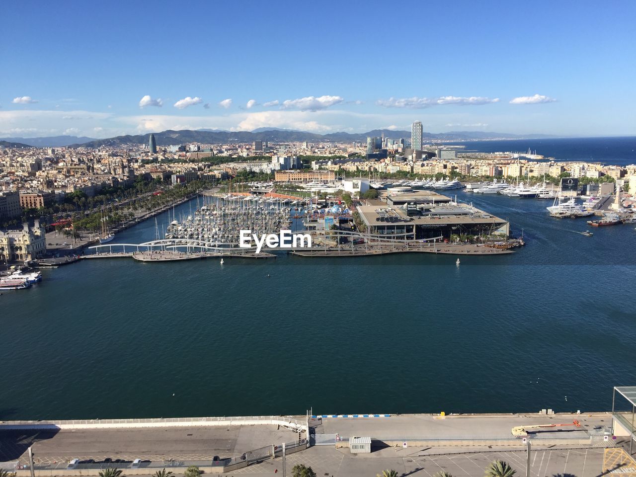 High angle view of cityscape by sea against sky