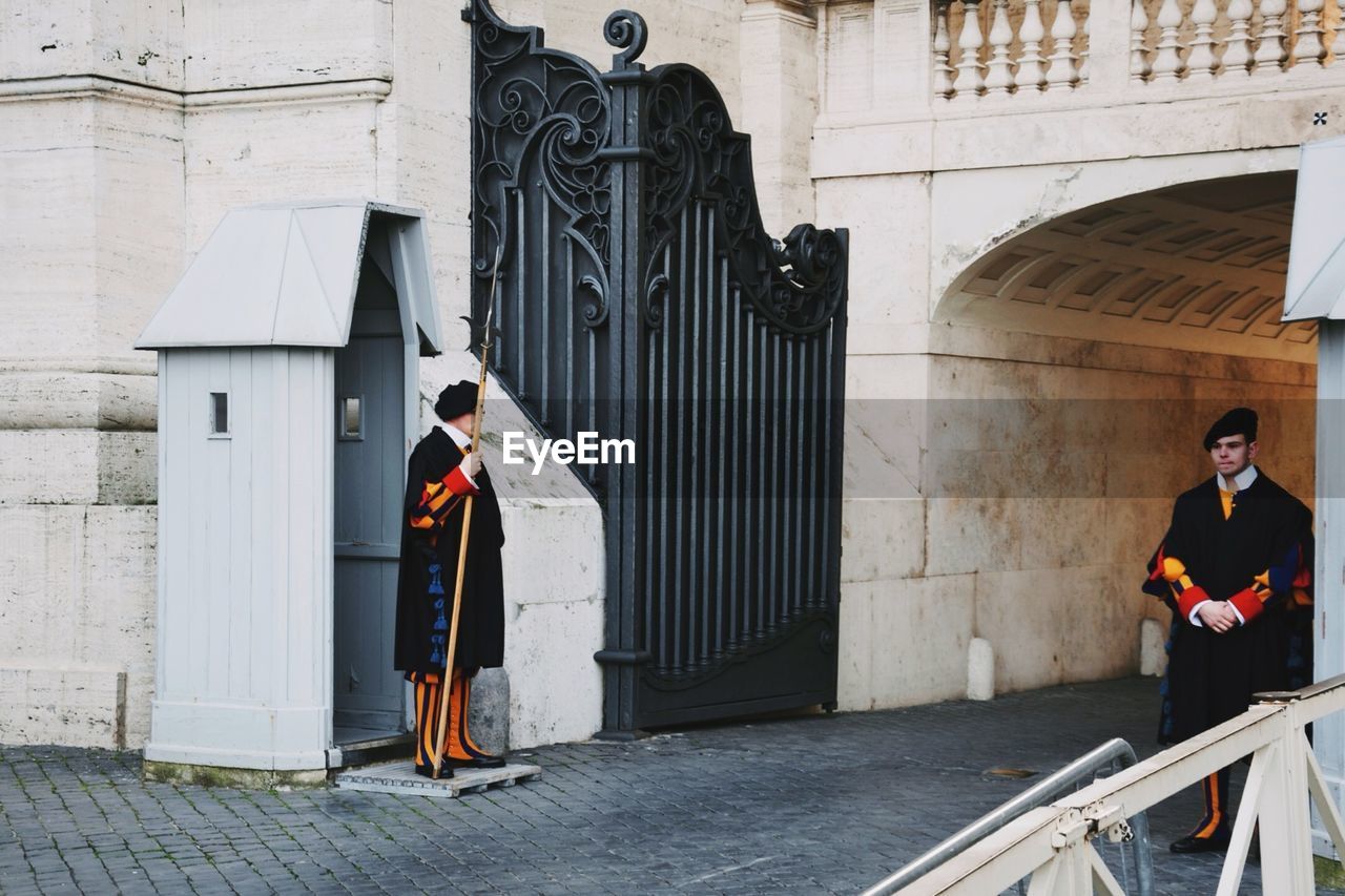 WOMAN STANDING IN CITY