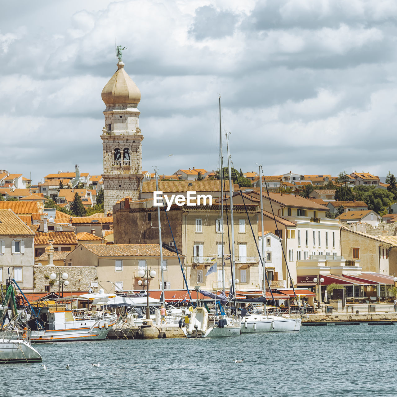 view of townscape by river against sky