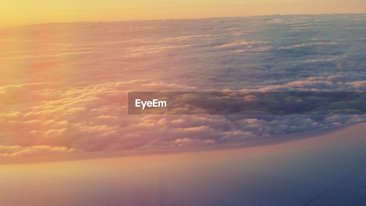 AERIAL VIEW OF CLOUDS OVER SEA DURING SUNSET