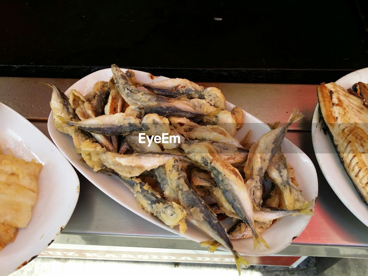 High angle view of fried fishes served in plates