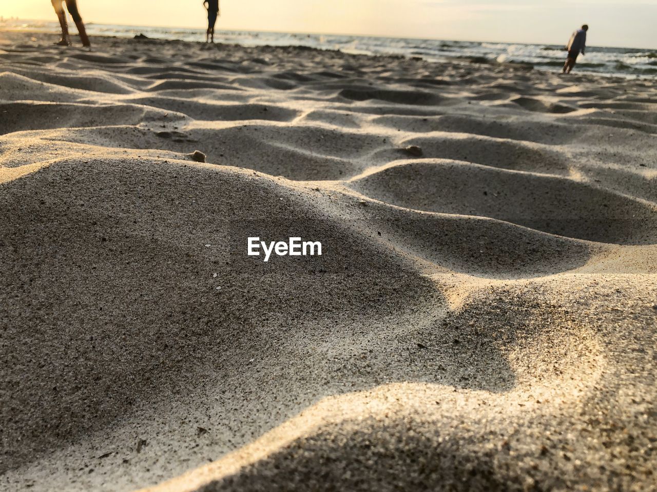 HIGH ANGLE VIEW OF FOOTPRINTS ON SAND