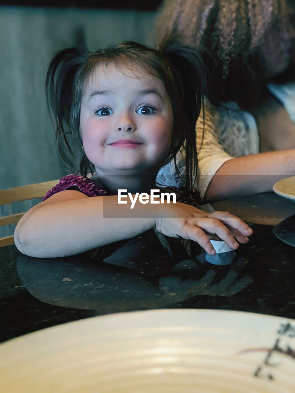 childhood, child, portrait, one person, skin, women, female, blue, looking at camera, cute, person, innocence, emotion, indoors, human face, food and drink, smiling, sitting, lifestyles, domestic room, baby, front view, happiness, water, headshot, toddler, table, portrait photography, food