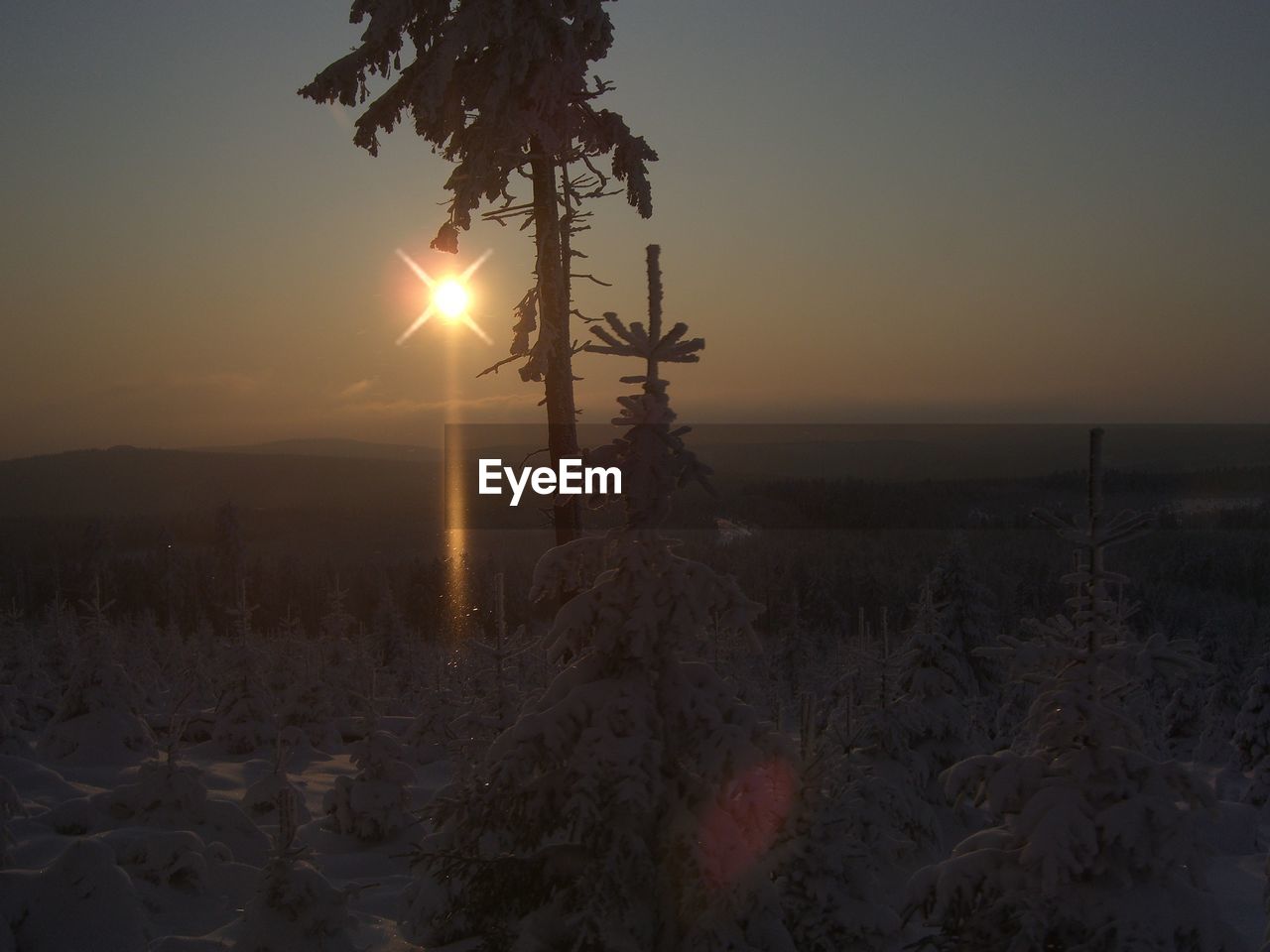 SCENIC VIEW OF SNOW COVERED LAND DURING SUNSET