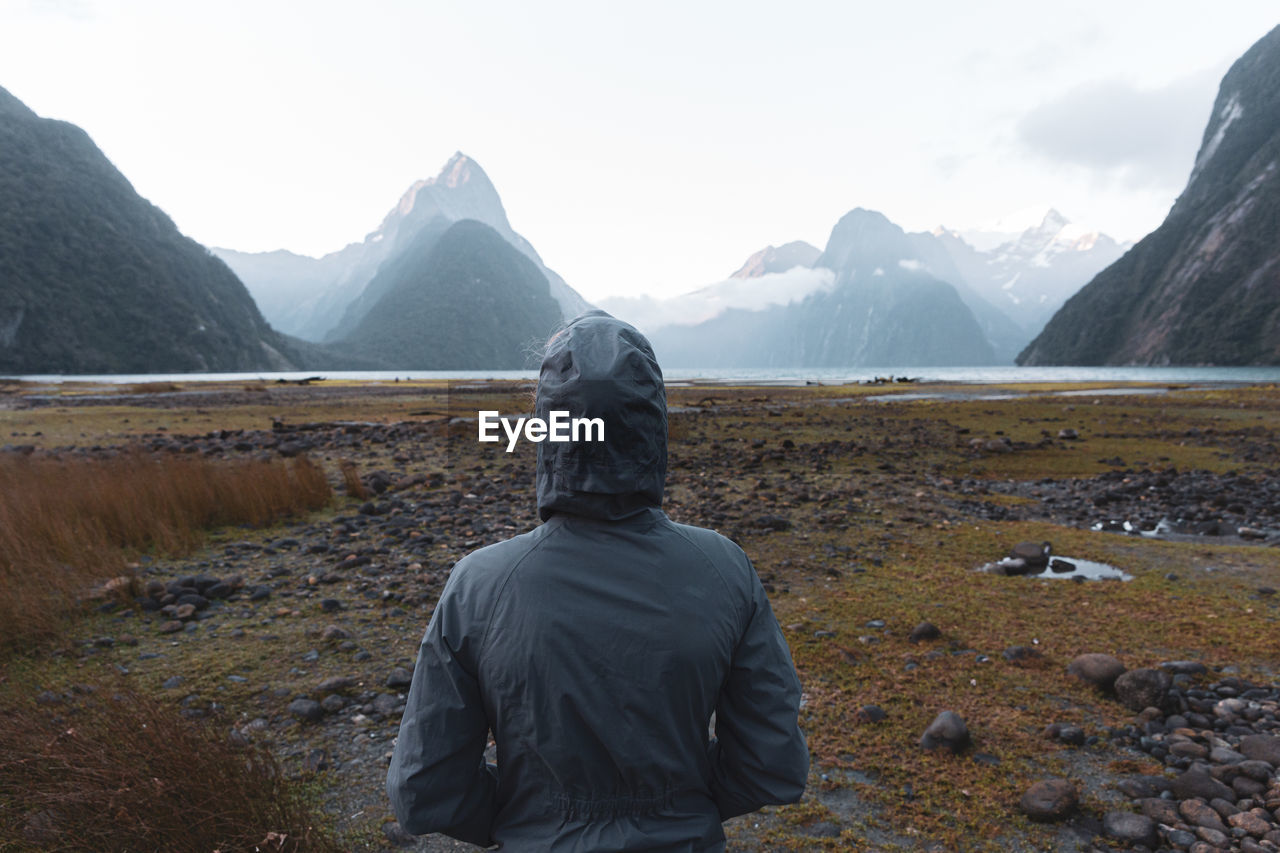 Rear view of person in mountains against sky