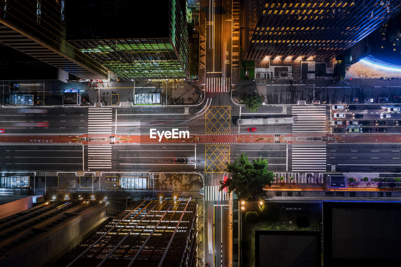 Light trails on city street by buildings at night