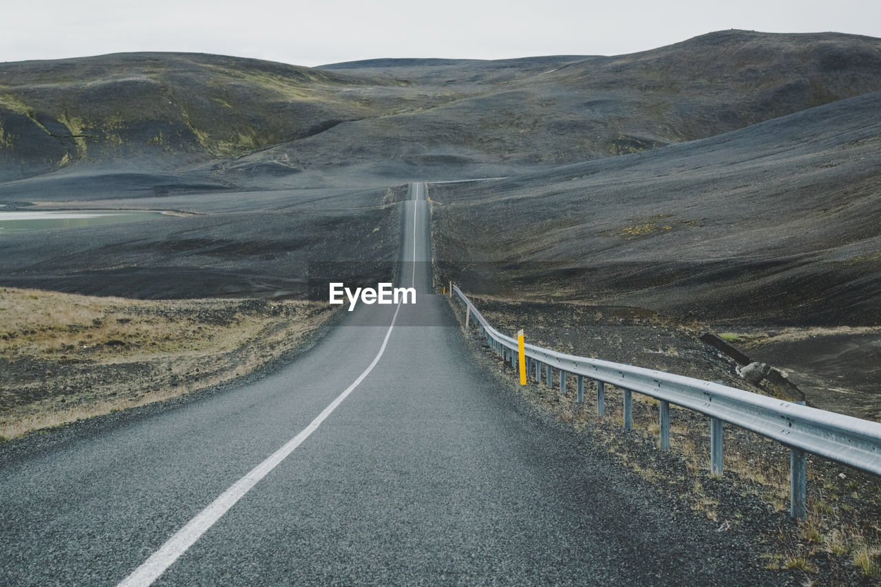 Empty road leading towards mountains