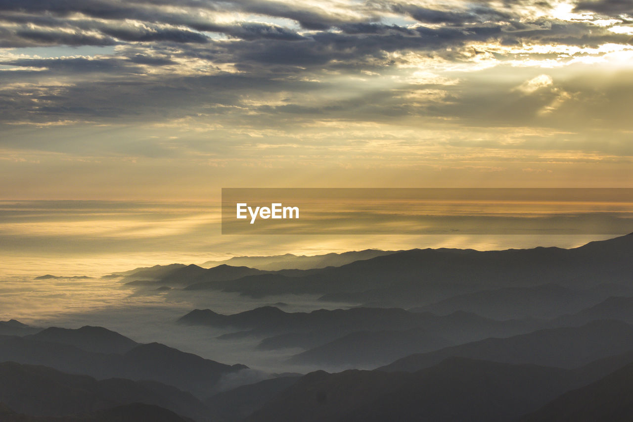 Scenic view of silhouette mountains against sky at sunset