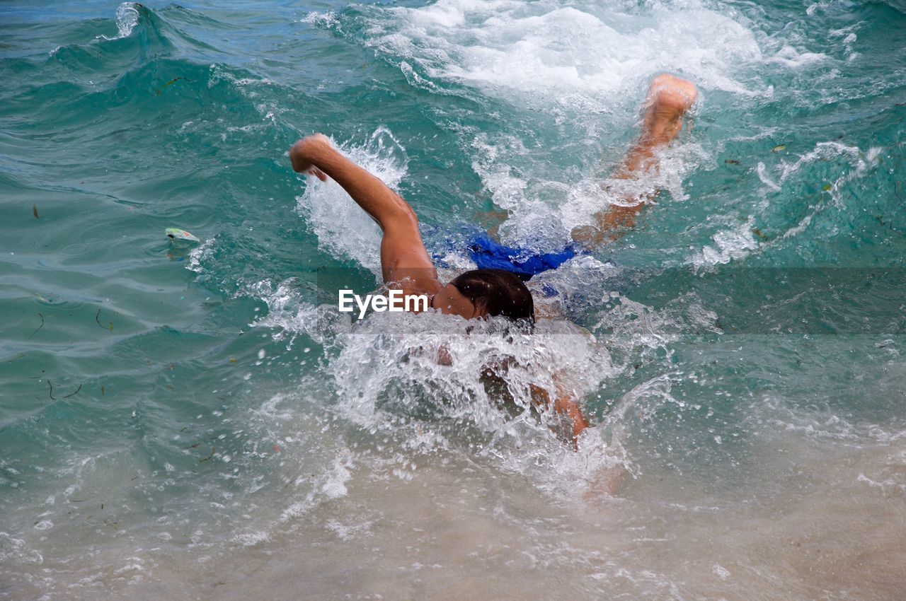 High angle view of man swimming in sea