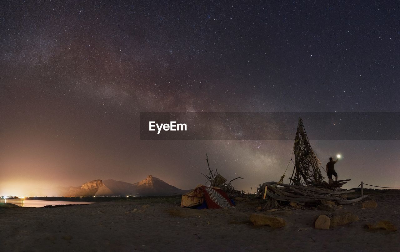 Scenic view of beach against sky at night