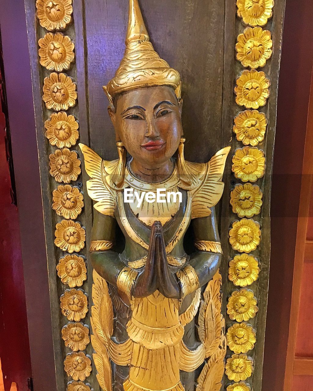 CLOSE-UP OF BUDDHA STATUE AT TEMPLE