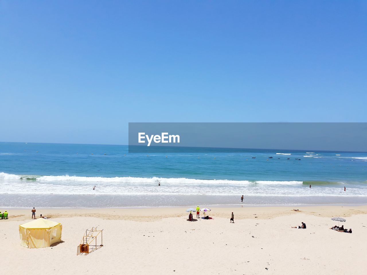 PEOPLE ON BEACH AGAINST SKY