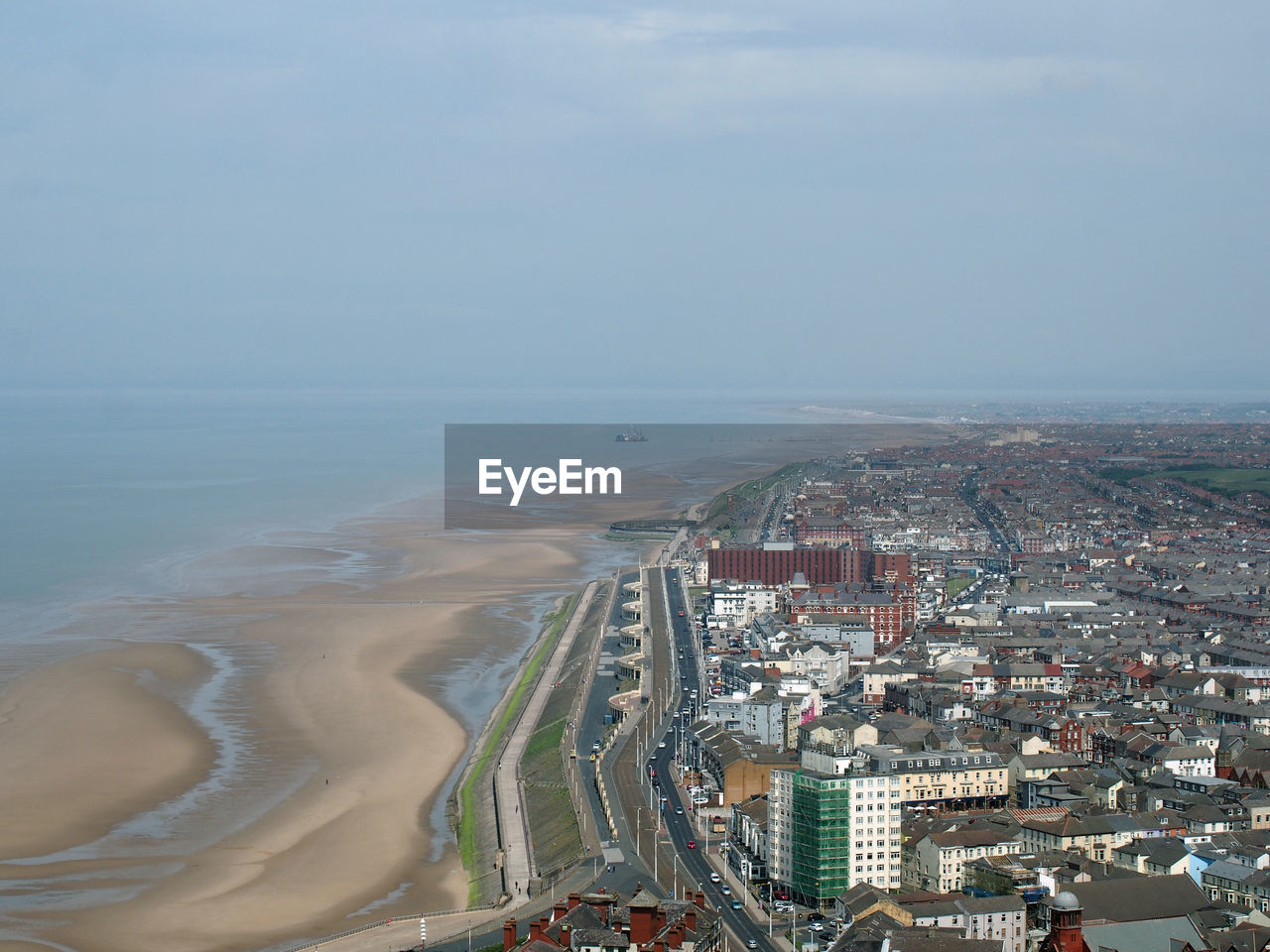 High angle view of sea and buildings against sky