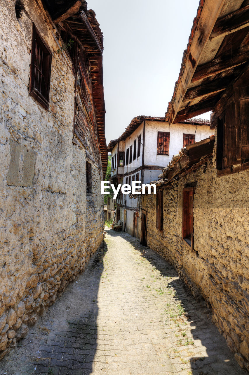 FOOTPATH AMIDST BUILDINGS IN TOWN