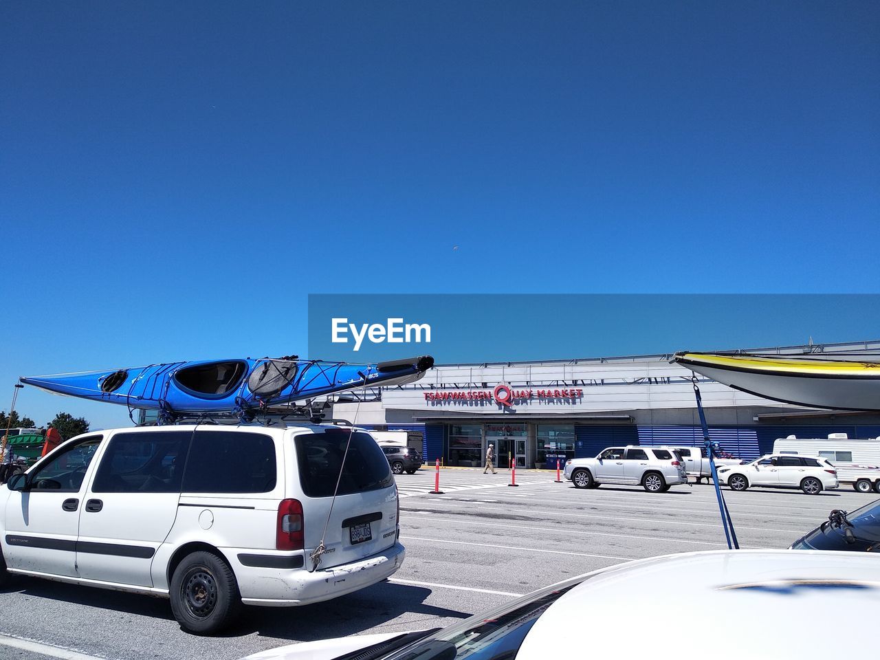 VEHICLES ON ROAD AGAINST BLUE SKY