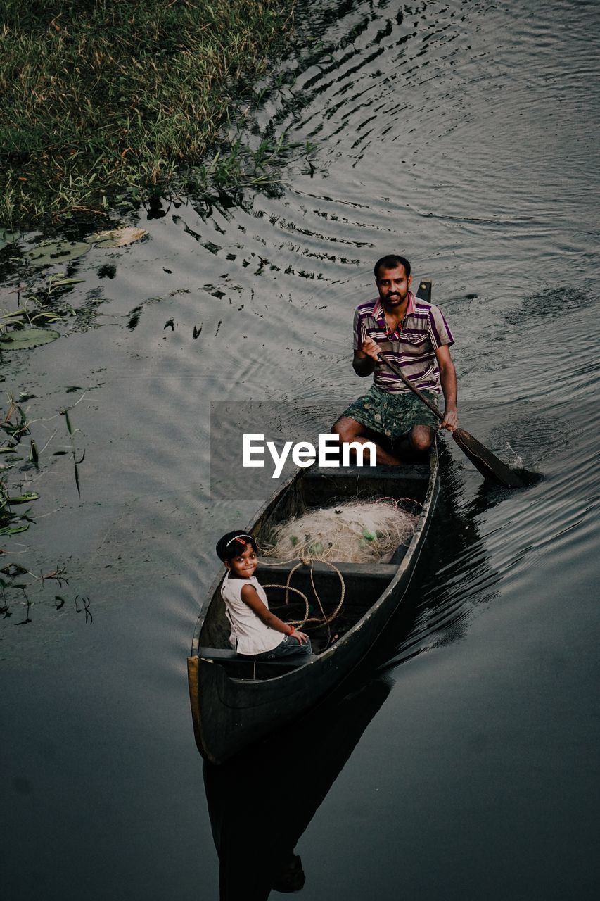 High angle portrait of man in boat on lake