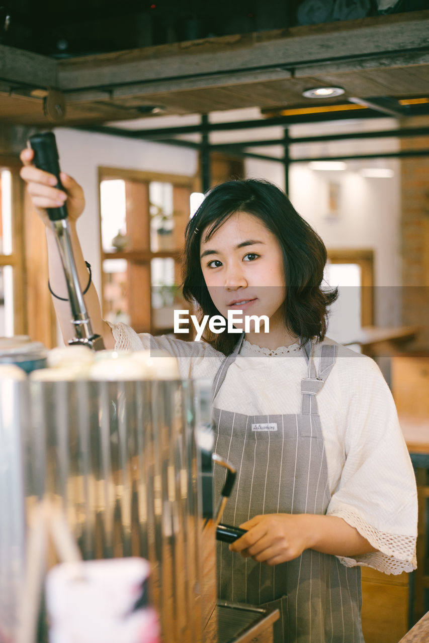 Portrait of a smiling barista girl.