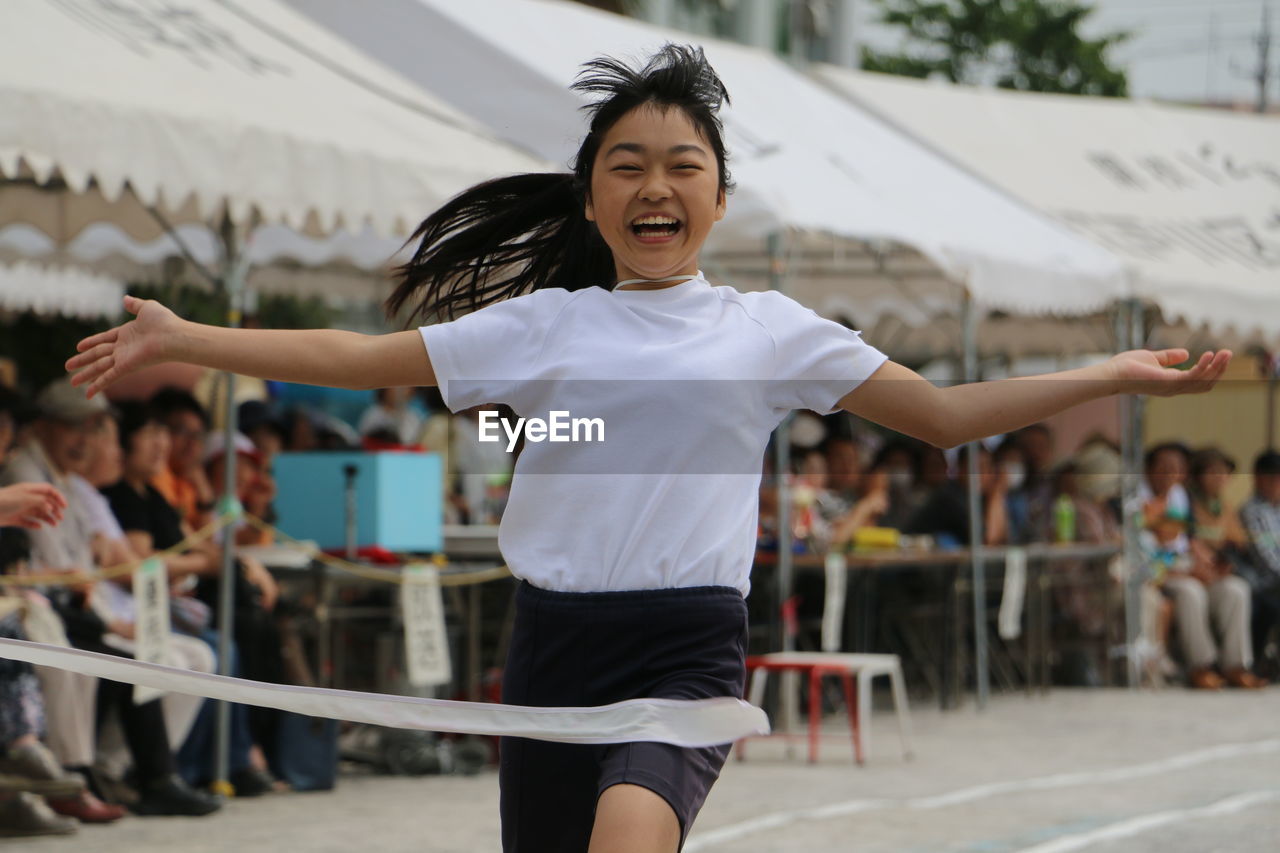 Happy woman running on track