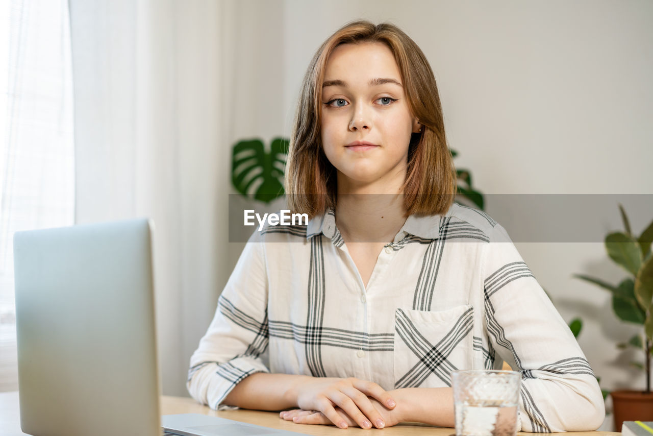  female freelancer working at home office. girl using a computer for study online at home. 