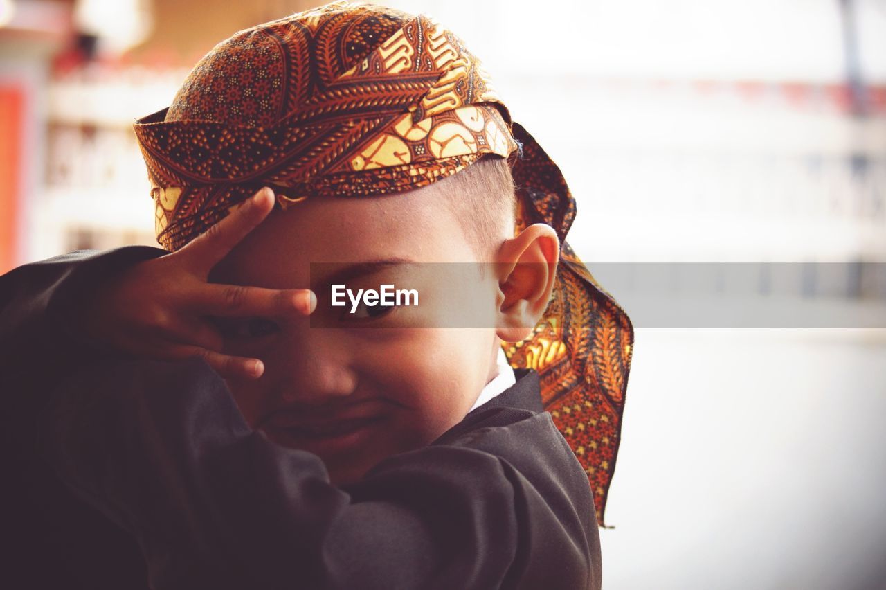 Close-up of cute boy in costume gesturing