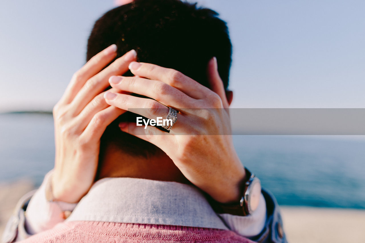 Close-up of couple embracing at beach