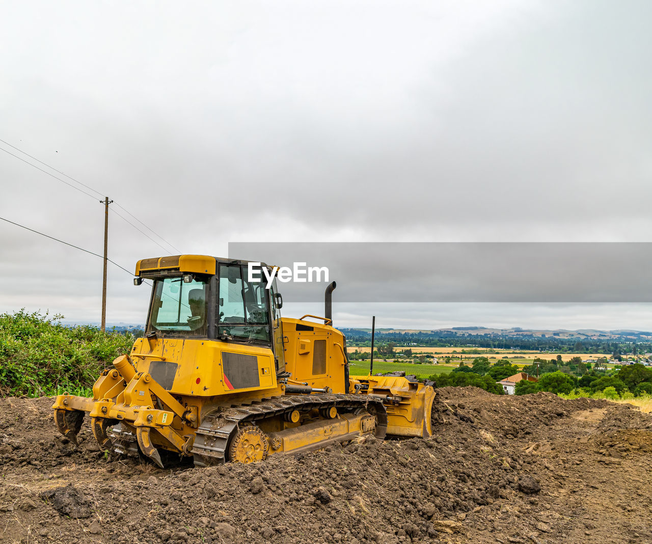 construction machinery, construction industry, agriculture, soil, transportation, industry, construction site, machinery, field, asphalt, earth mover, mode of transportation, land vehicle, vehicle, sky, road construction, digging, tractor, road, nature, landscape, construction vehicle, construction equipment, cloud, land, environment, bulldozer, equipment, development, yellow, occupation, dirt, copy space, overcast, working, construction, rural scene, plant, agricultural machinery, day, industrial equipment, transport, outdoors, agricultural equipment, no people