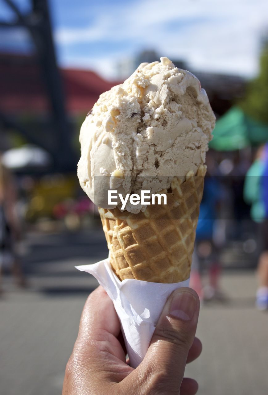 Close-up of hand holding ice cream cone