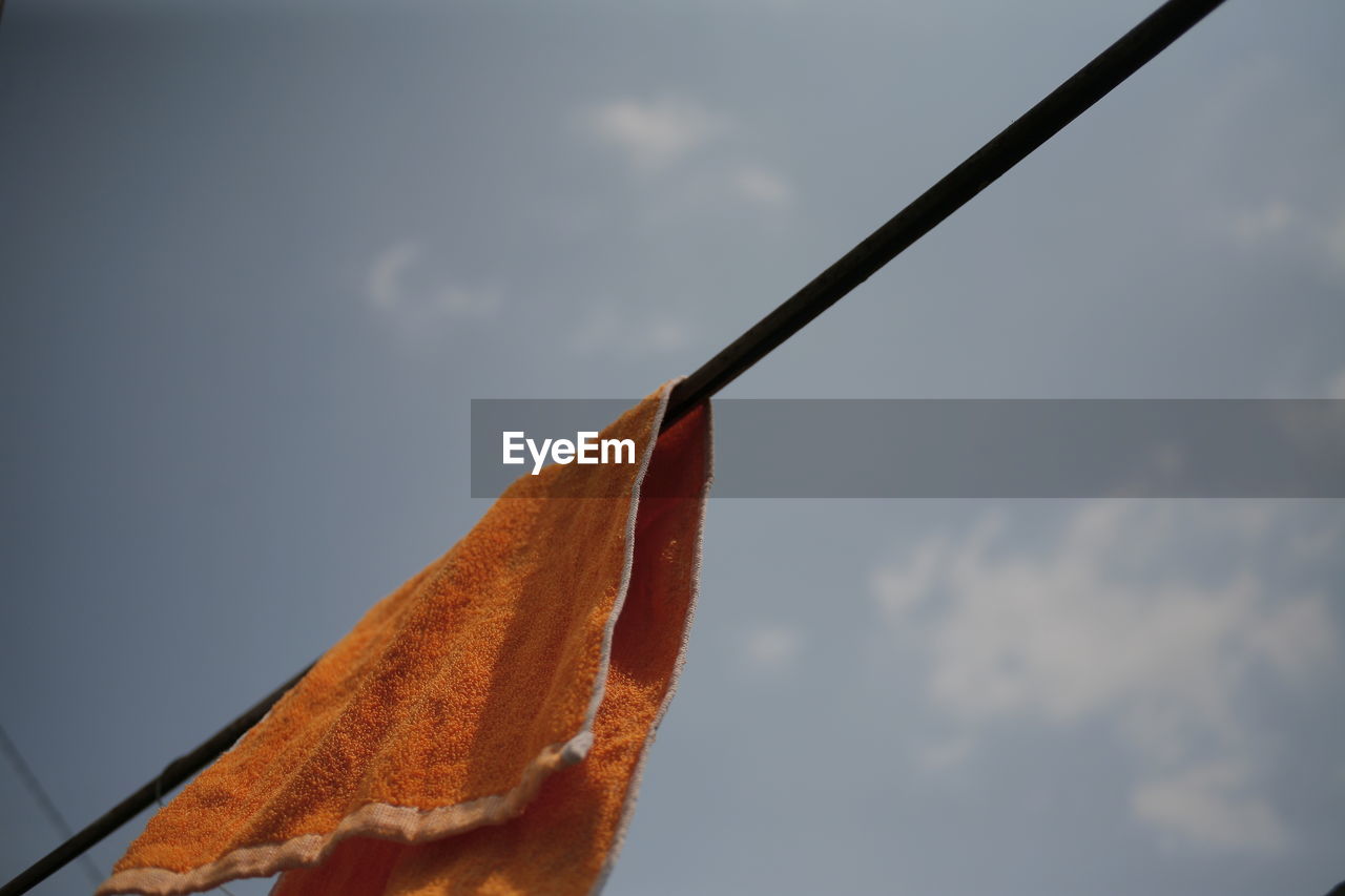 Low angle view of towel against sky