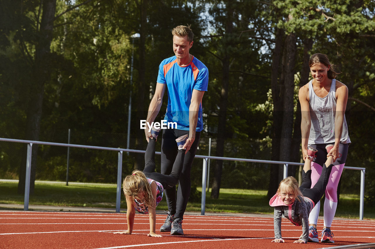 Parents with daughters on running track