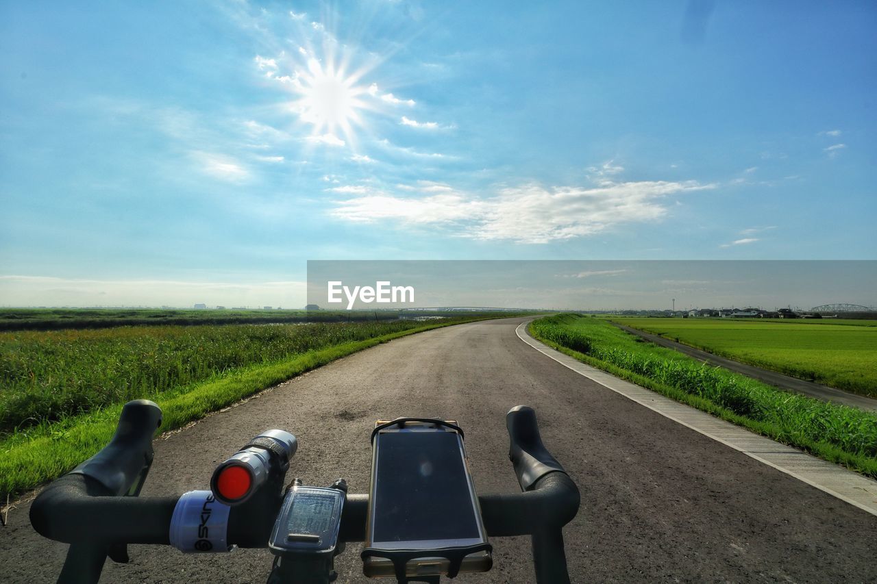 EMPTY ROAD AMIDST FIELD