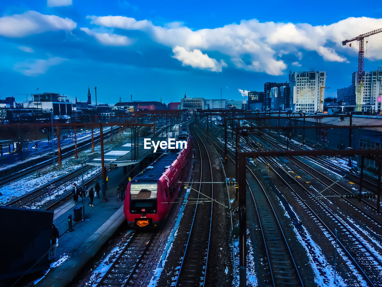 High angle view of railroad tracks in city against sky during dusk