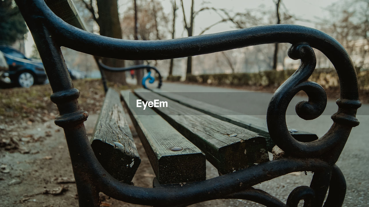 Close-up of metal bench in park