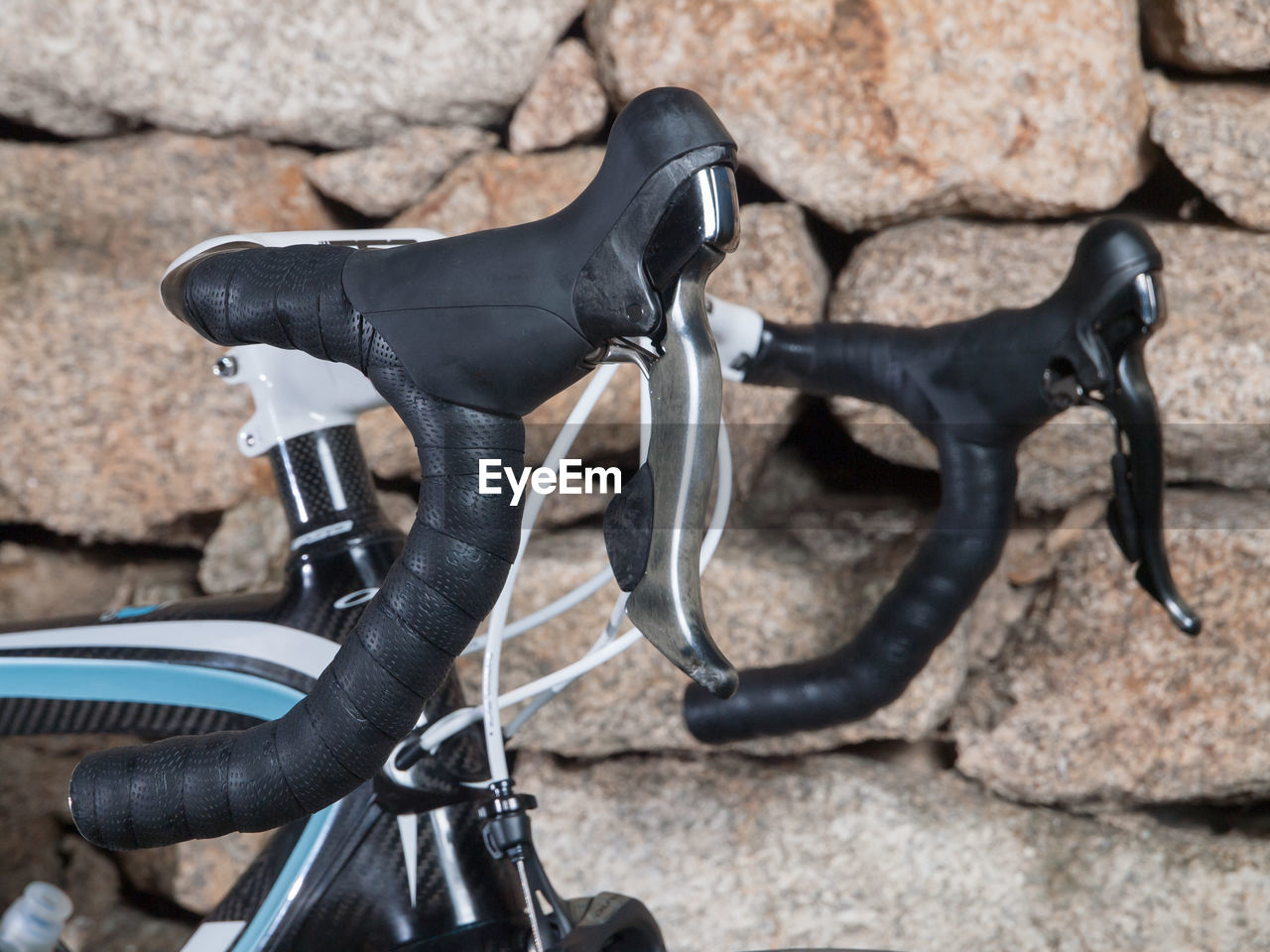 Close-up of bicycle against stone wall