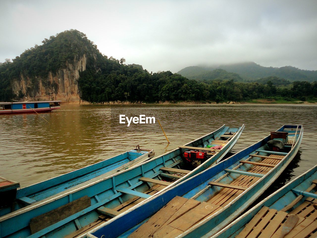 Boats moored on lake against sky