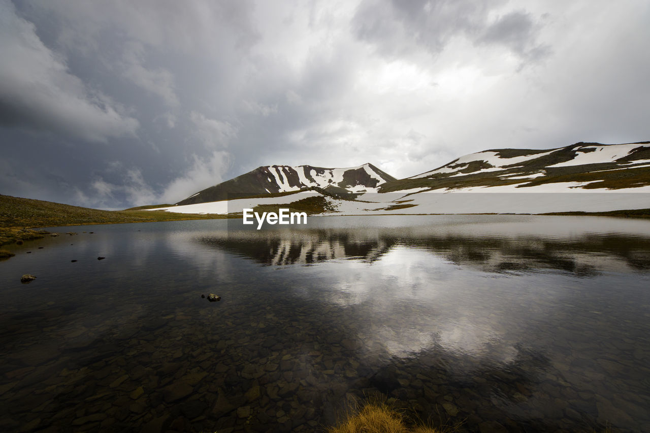 Alpine mountain lake landscape and view, snow and clouds in javakheti, georgia