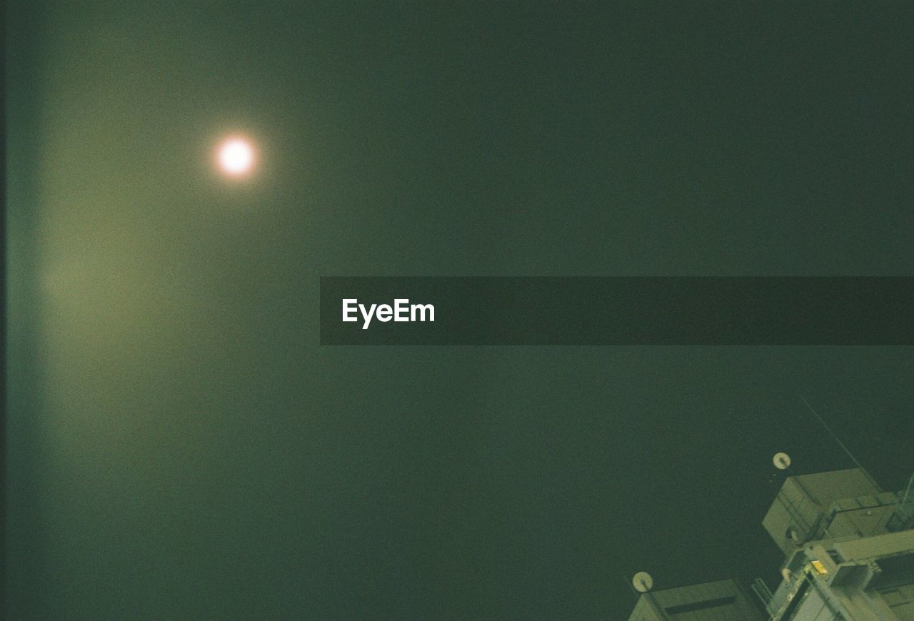 LOW ANGLE VIEW OF MOON AT NIGHT