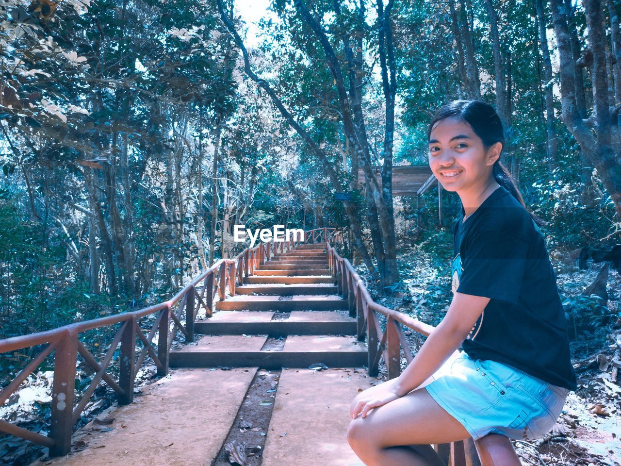 Woman sitting in forest