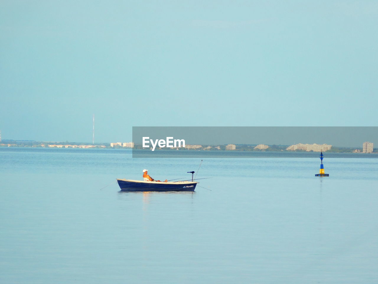 Boat moored on sea against clear sky