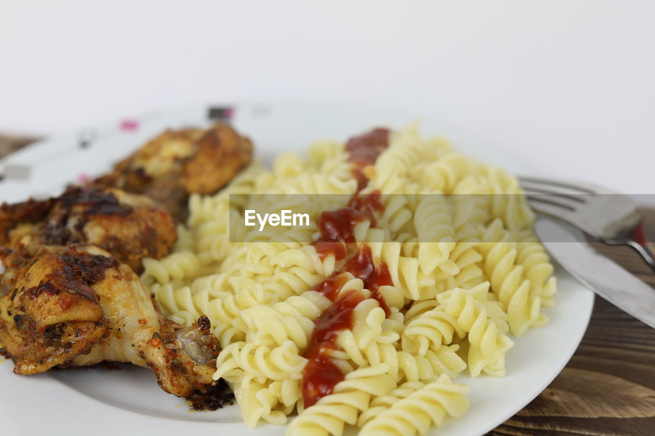 food, food and drink, fusilli, rotini, plate, freshness, cuisine, healthy eating, dish, wellbeing, italian food, indoors, spaghetti, pasta, meal, vegetable, fork, no people, close-up, produce, eating utensil, meat, kitchen utensil, focus on foreground, dinner, vegetarian food